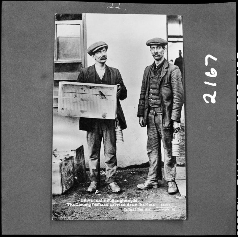 Black and white film negative showing two men, one of whom is carrying a canary in a cage, Universal Colliery, 1913.  &#039;Sen 1913&#039; is transcribed from original negative bag.