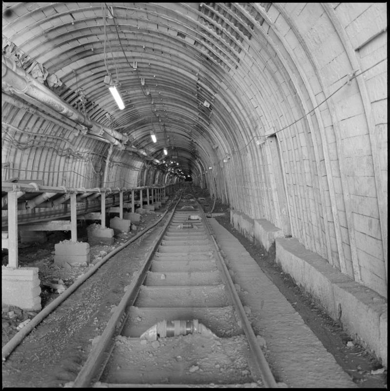 Black and white film negative showing an underground roadway and conveyor, Treforgan Colliery.