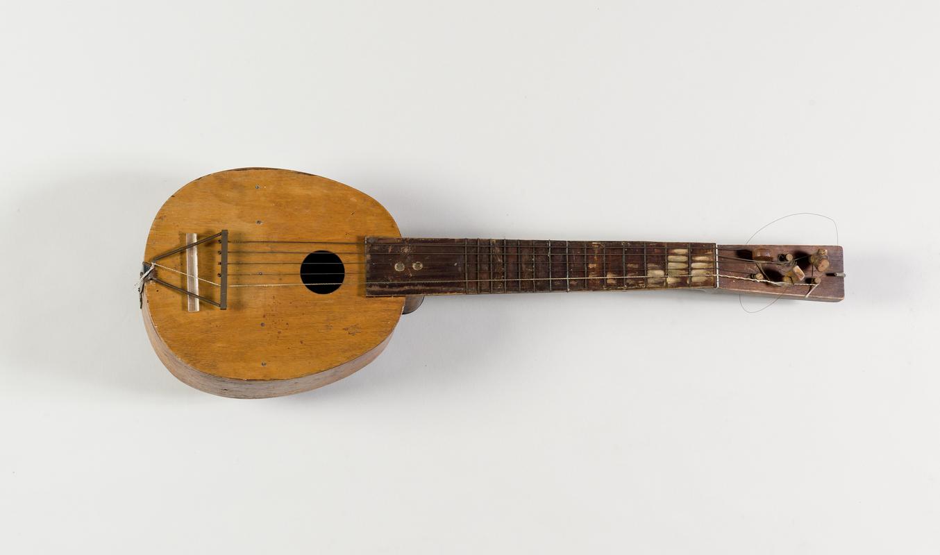 Guitar made by Mr Gwion Davies whilst on the SOUTHERN EMPRESS during a sea voyage to the South Atlantic whaling grounds in 1940/41.