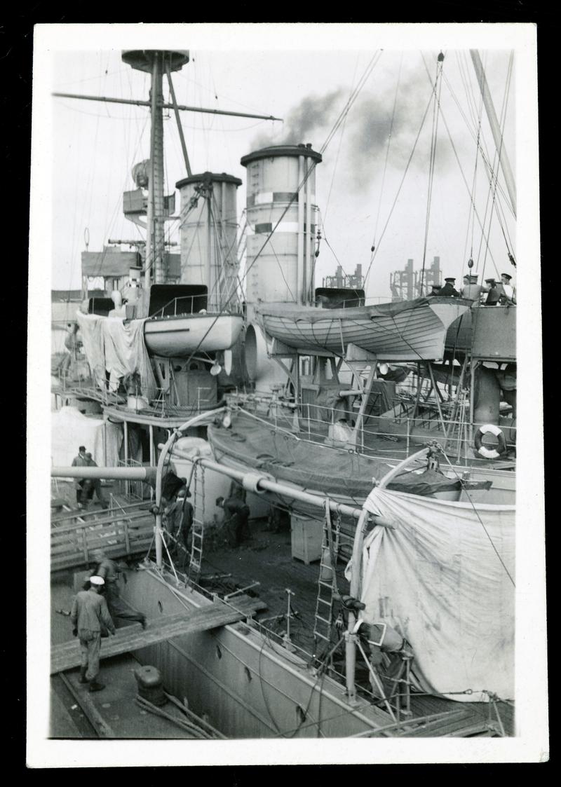 The Swedish cruiser FYLGIA bunkering at Queen Alexandra Dock, Cardiff, pre-1923. View of deck seen from dockside crane.