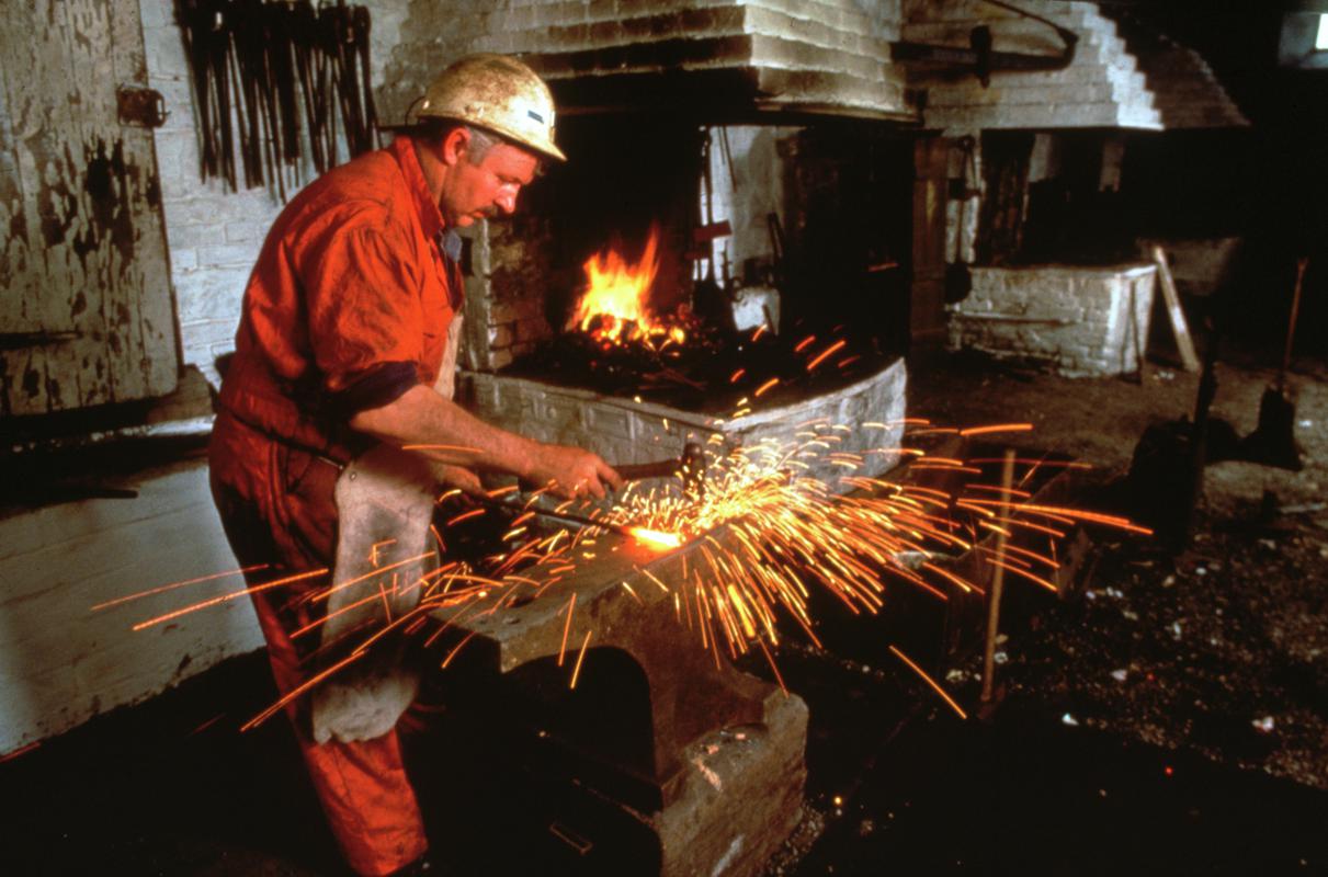 Blacksmith at work in blacksmith shop at Big Pit