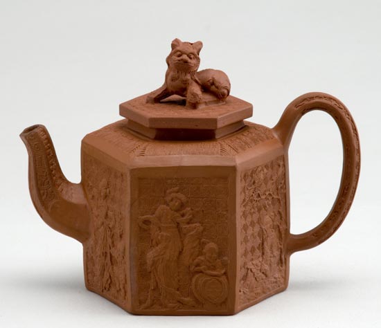 Red stoneware teapot with moulded chinoiserie decoration