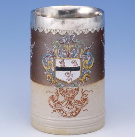 Silver-mounted stoneware mug, enamelled with the arms of Farmer, Fulham, 1706
