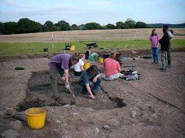 Removing the charred deposit in Mark Lewis' trench.