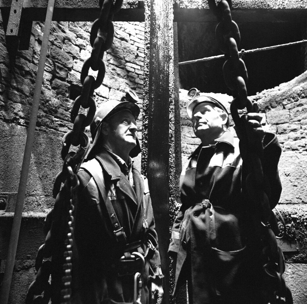 Deep Duffryn Colliery, two pitmen inspecting the shaft from the roof of the cage, 1977-78.