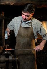 Andrew Murphy using the jig at St Fagans National Museum of History to recreate Roman arrowheads