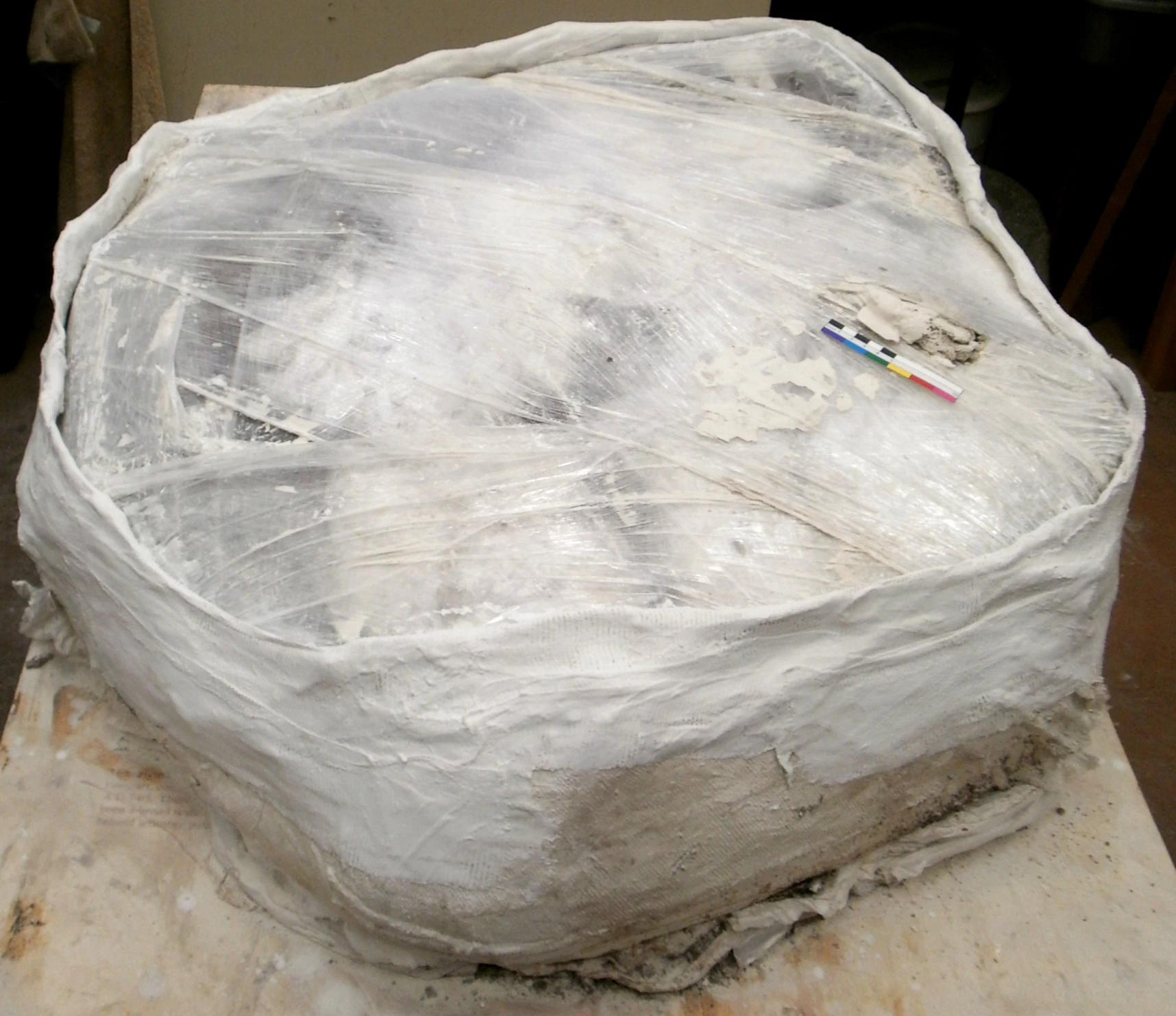 The Clingfilm layer which had been protected the iron underneath from the Plaster of Paris bandages. The sides of the block had been carefully re-bandaged to ensure that the soil block held together. 