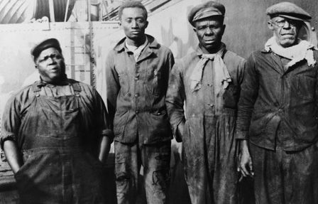 Four black firemen aboard a Radcliffe ship during the Second World War