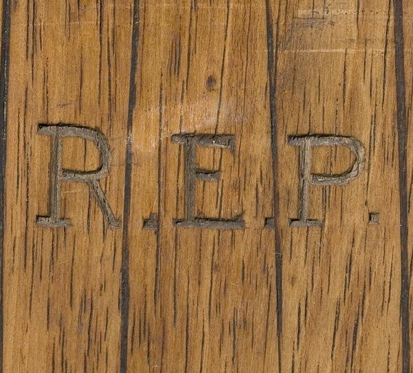 The initials of Raymond Edward Priestley are carved into each ski. 