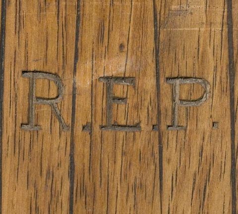 The initials of Raymond Edward Priestley are carved into each ski. 