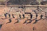 Volunteers marking the location of postholes of a large timber hall predating Building 2