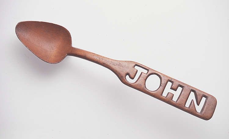 Lovespoon with narrow panel handle with the name 'John' in fretwork