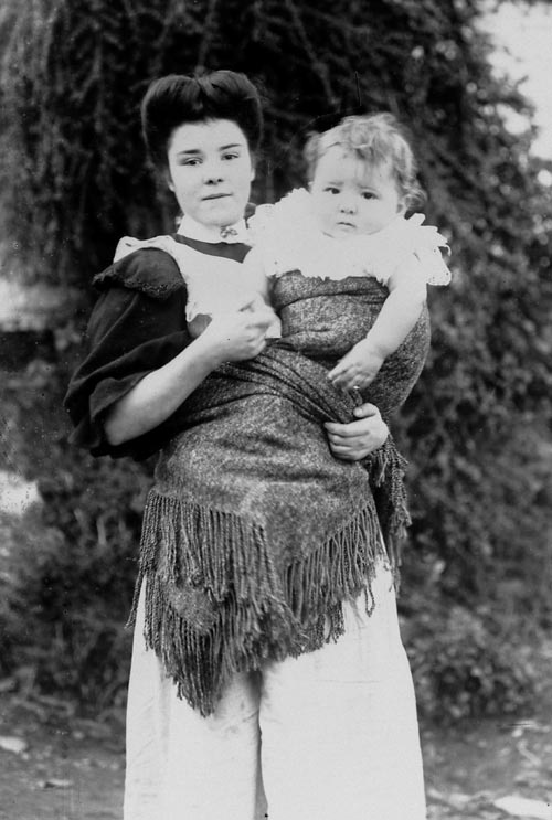 An unidentified girl carrying a baby in a shawl 'Welsh fashion'.