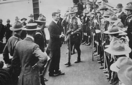 Commander Evans returns the flag to Scoutmaster T.W. Harvey on board the <em>Terra Nova</em> on 17 June 1913.