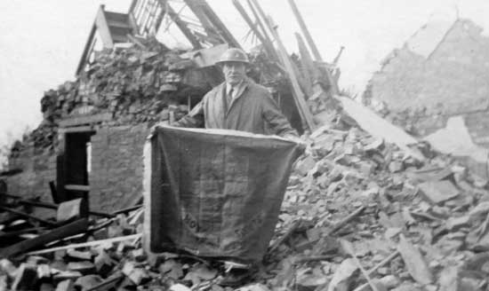 The flag being retrieved from the rubble of the scout hall in Wyverne Road, Cathays, Cardiff after the German bombing raid of 30 April 1941