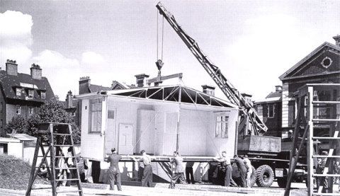 An aluminium prefab prototype being installed, ready for exhibition, outside the Tate Gallery in London, 1945. Crown copyright NMR