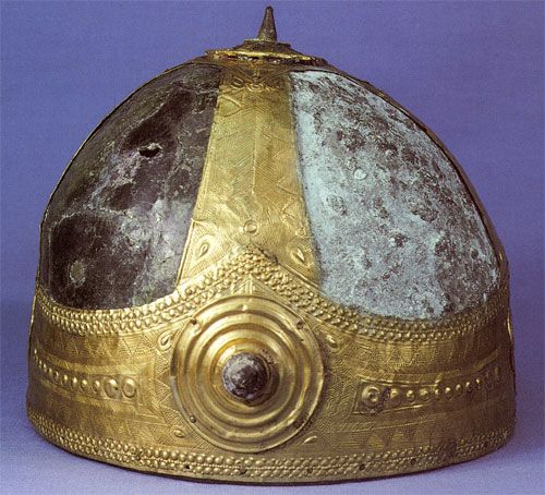 Etruscan bronze 'helmet' embellished with gold showing half of the false patina removed