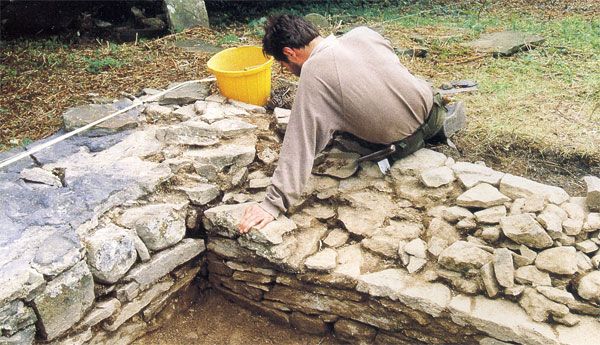 Cleaning the south wall of the medieval church