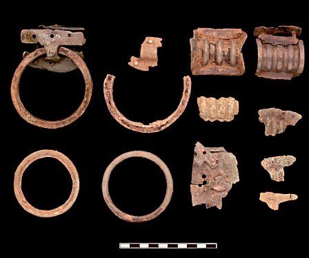 Handles and straps from cauldrons and bowls found at Llanmaes. Cauldrons were large bronze vessels used during feasts.