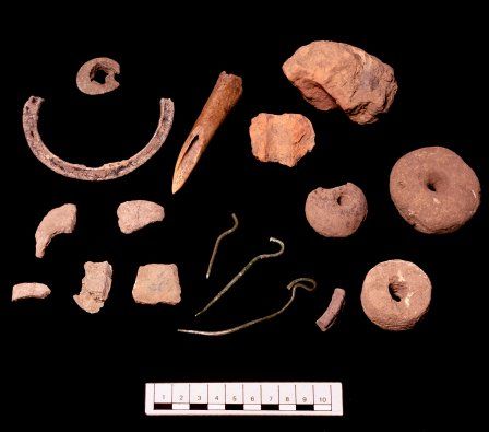 Finds from Llanmaes 2004: axe and cauldron fragments, swan's neck pins, spindle whorls and loom-weights.
