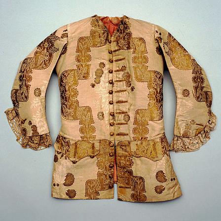 Man's short coat, dating to the early 1720s. The fabric is white taffeta with a lace pattern.