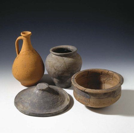 Range of vessels found at Usk Roman fortress - a flagon for drinking, a jar for storage, a bowl for mixing or cooking, and a large lid, probably used during cooking.