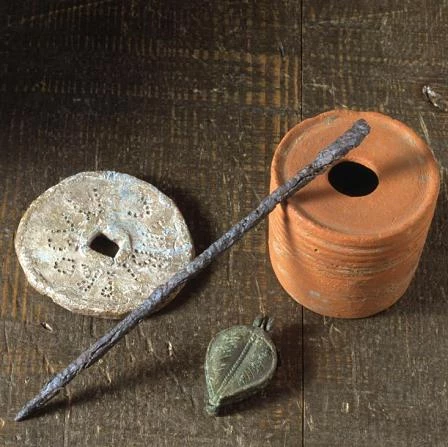 Pottery inkwell, an iron stylus for writing on waxed tablets, a seal box and a lead property marker.
