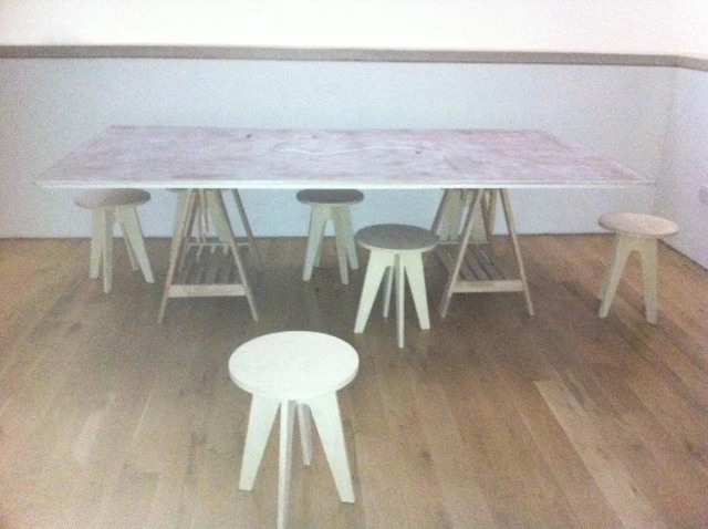 A lovely big table where people can sit and chat about their stories. 