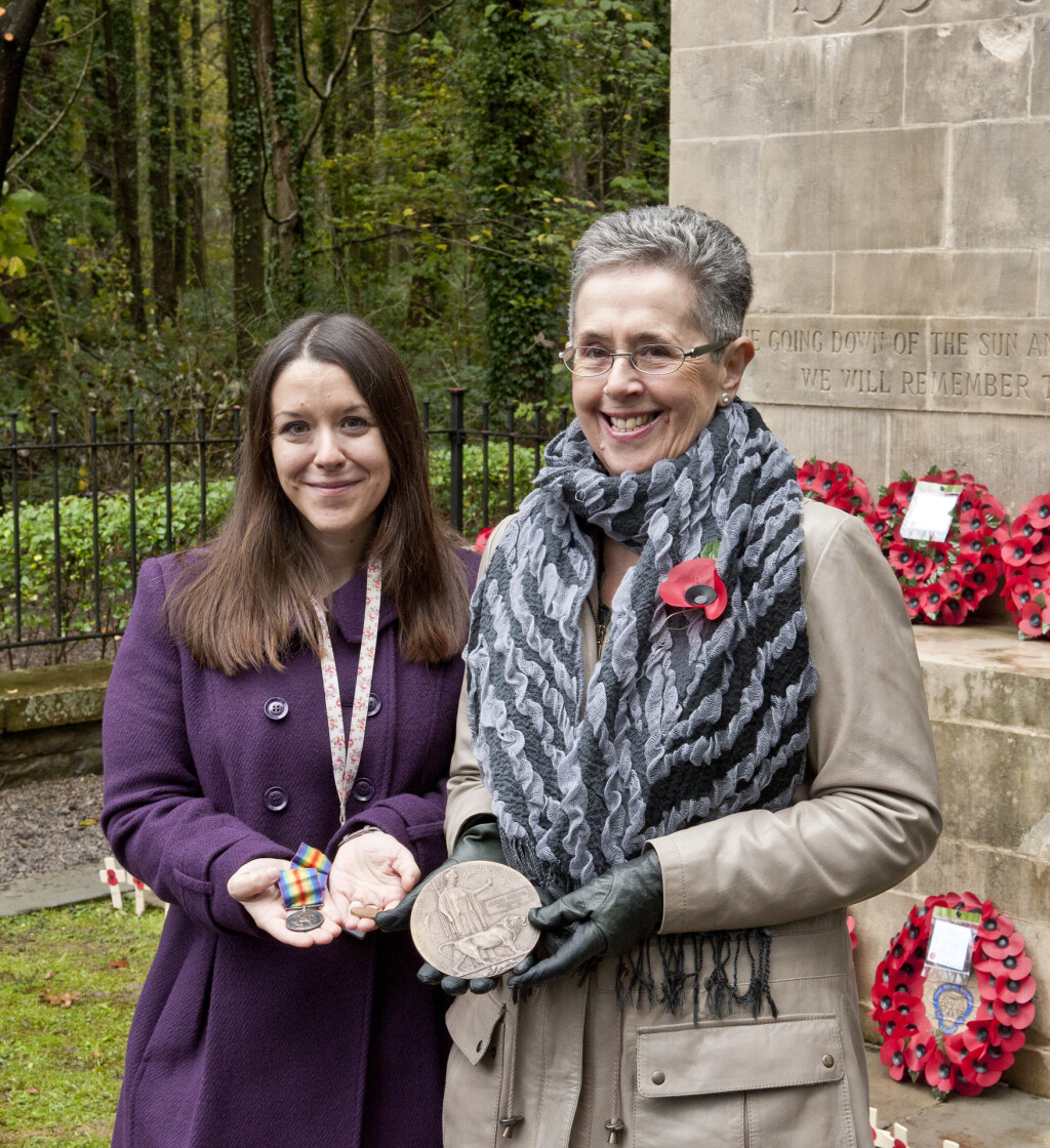 Mrs Gaynor Hoare (left) presenting Alfred Prosser Workman's campaign medals and memorial plaque to the Museum, November 2014. She is holding the medals in her hand in front of the Newbridge War Memorial.