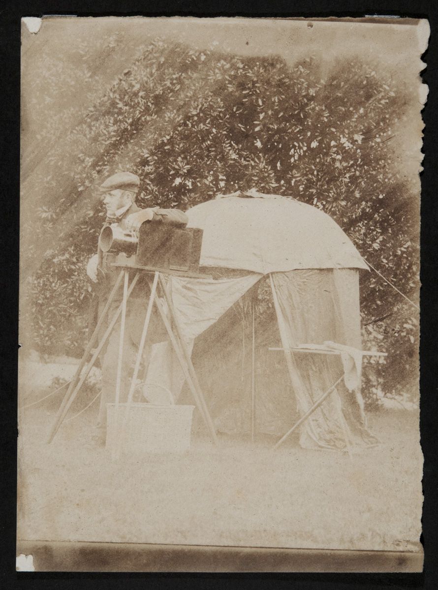 Salted paper print showing John with all the apparatus needed to take a collodion negative