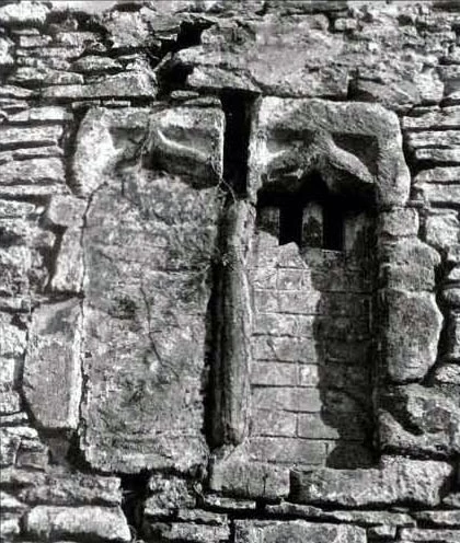 Stone mullioned medieval window uncovered from beneath layers of lime wash and render during the dismantling process