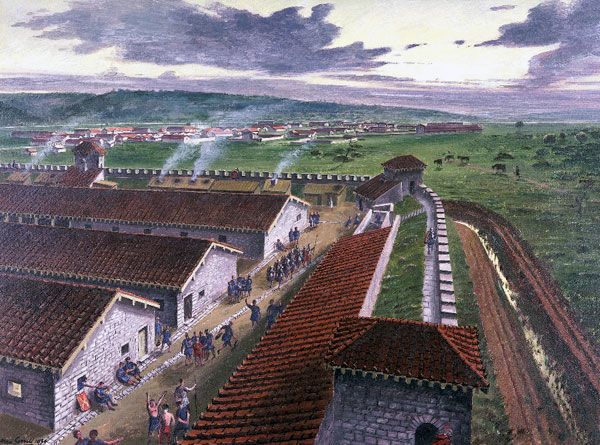 Barracks and other buildings in the west corner of the Roman legionary fortress, Caerleon, Monmouthshire, in the 2nd century AD; by Alan Sorrell, 1939. This reconstruction shows one corner of the barracks in Prysg Field, now laid out and on view to the pu