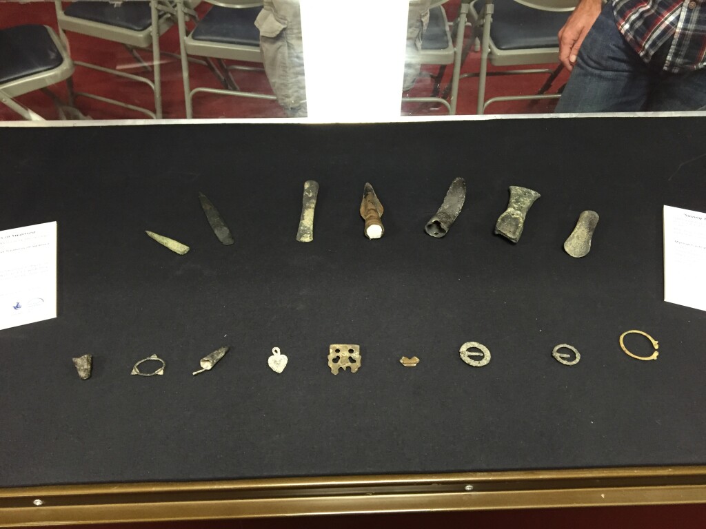 An open display case with a selection of small finds laid out inside