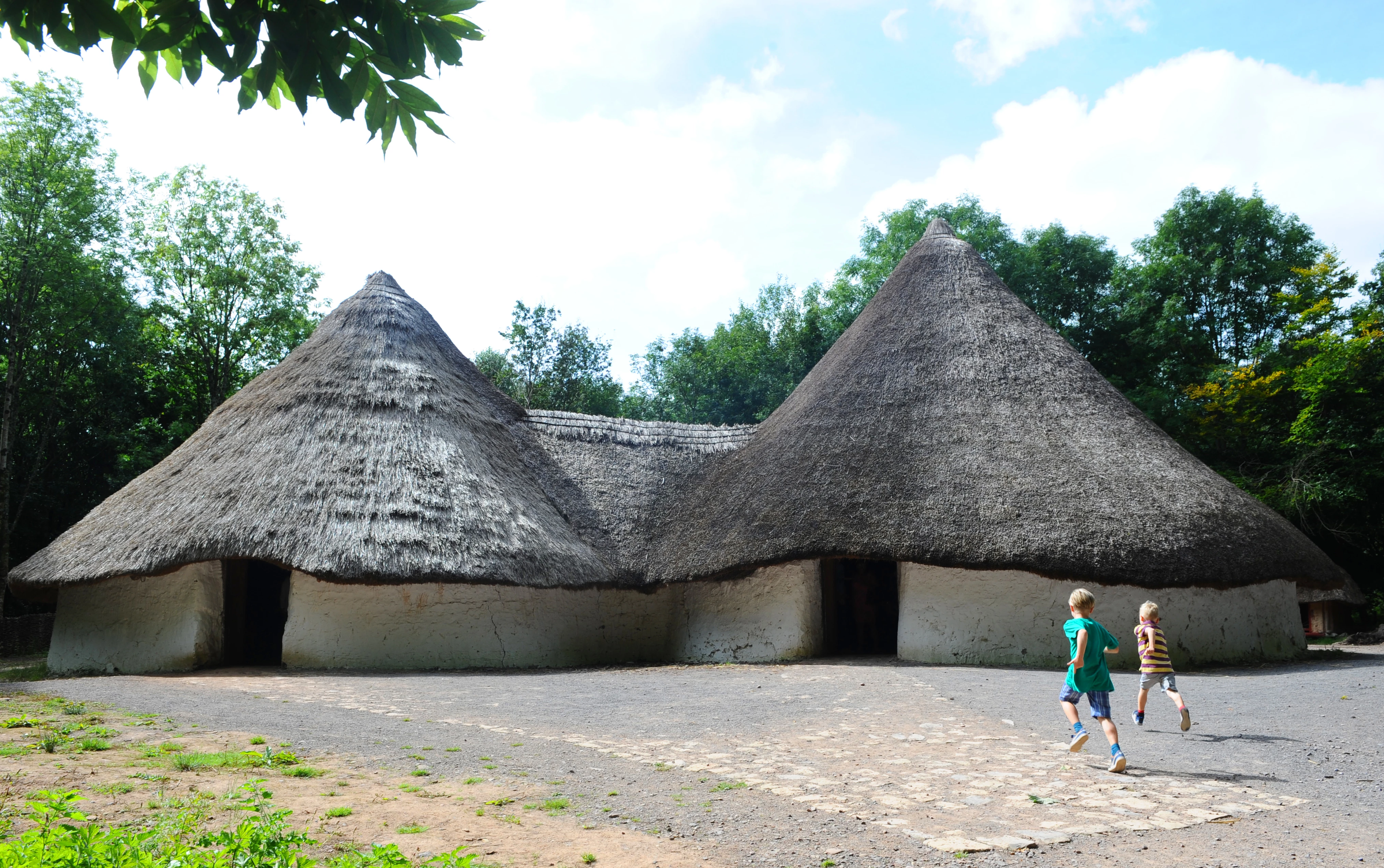 Children running towards Bryn Eryr, an Iron Age Farmstead 