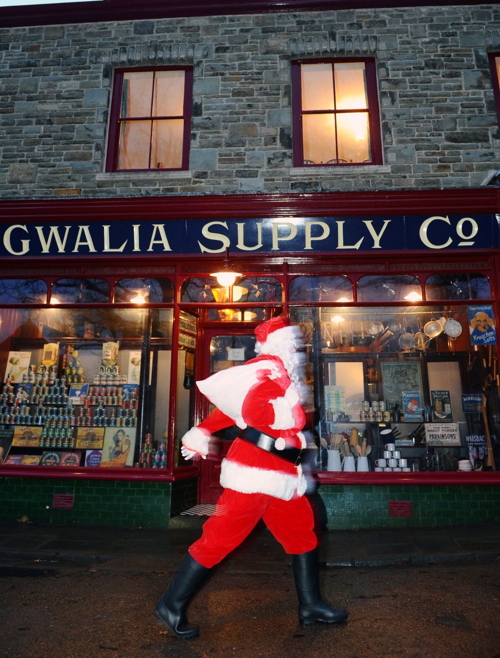 Father Christmas walking past Gwalia Stores