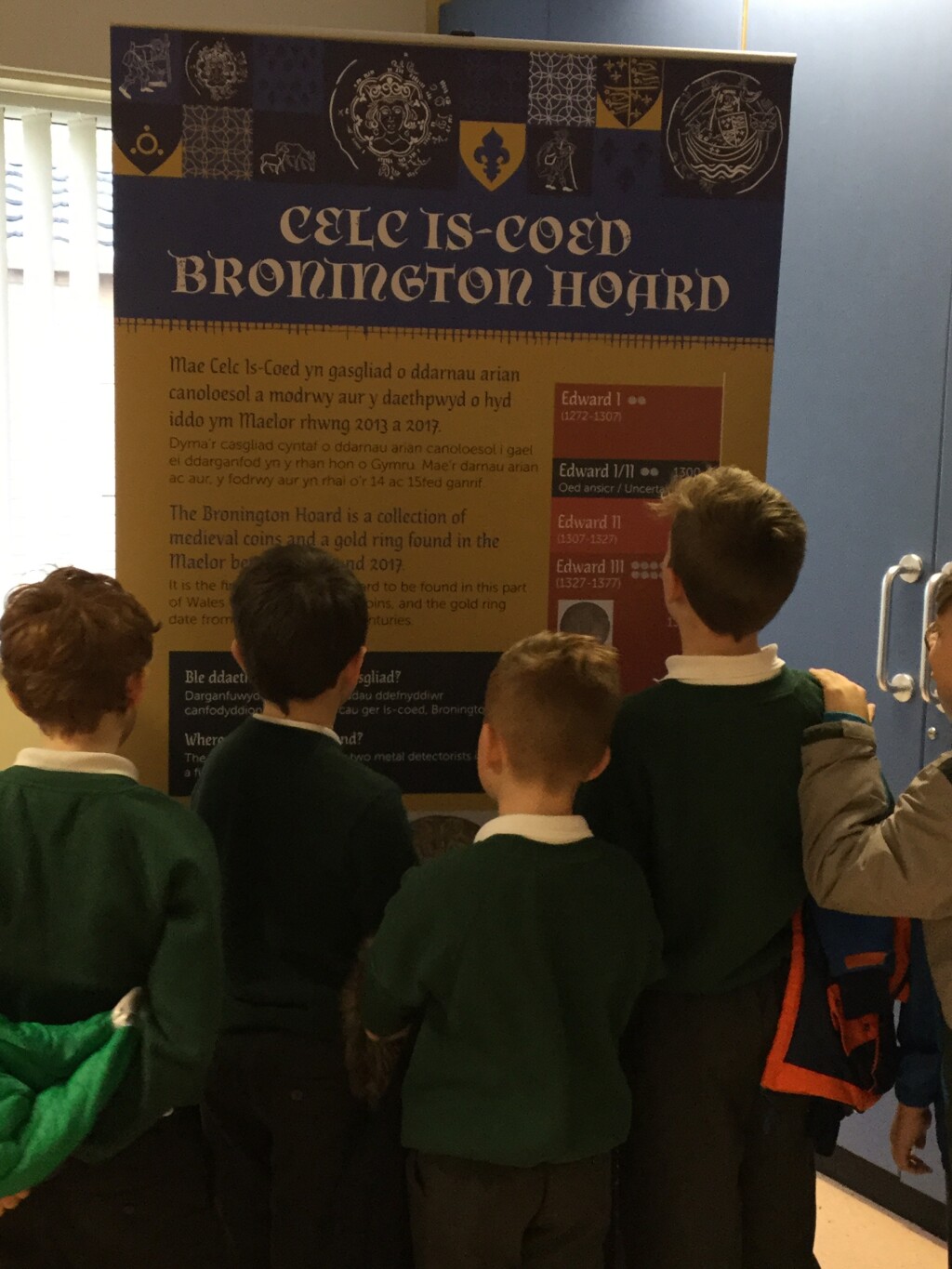 School children looking at an information panel on the Bronington Hoard
