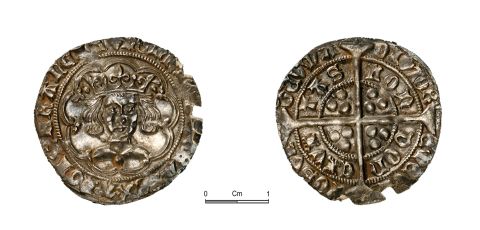 A picture of a detailed medieval silver coin, both sides shown