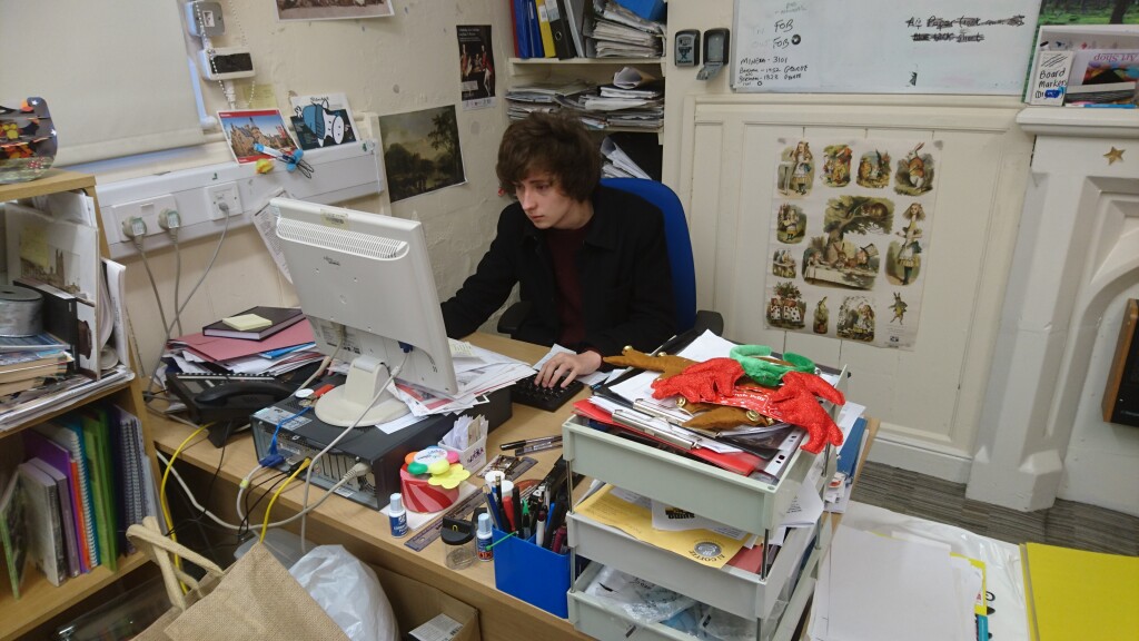 Student volunteer Tom working at his desk at Wrexham museum