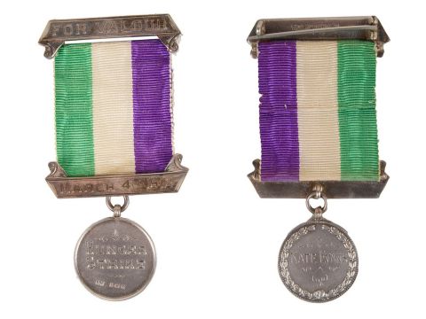 photo showing medal on a purple, white and green ribbon, which reads 'Hunger Strike' on the front, and 'Kate Evans' on the back