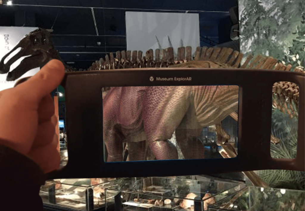 View of a visitor holding a device in the gallery showing augmented reality on the screen