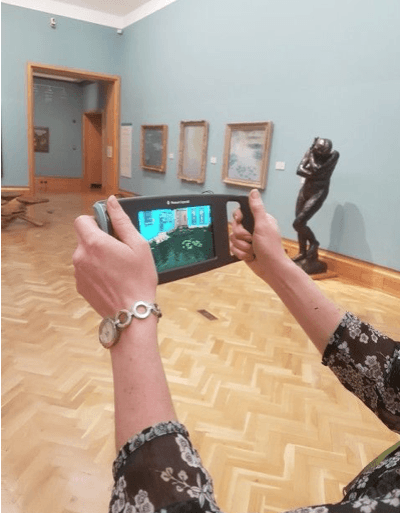 View of device in the Impressionist gallery showing augmented reality on the screen