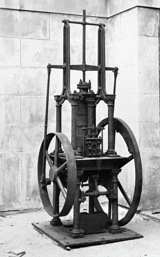 Black and white photo of a piece of machinery, similar to an engine.