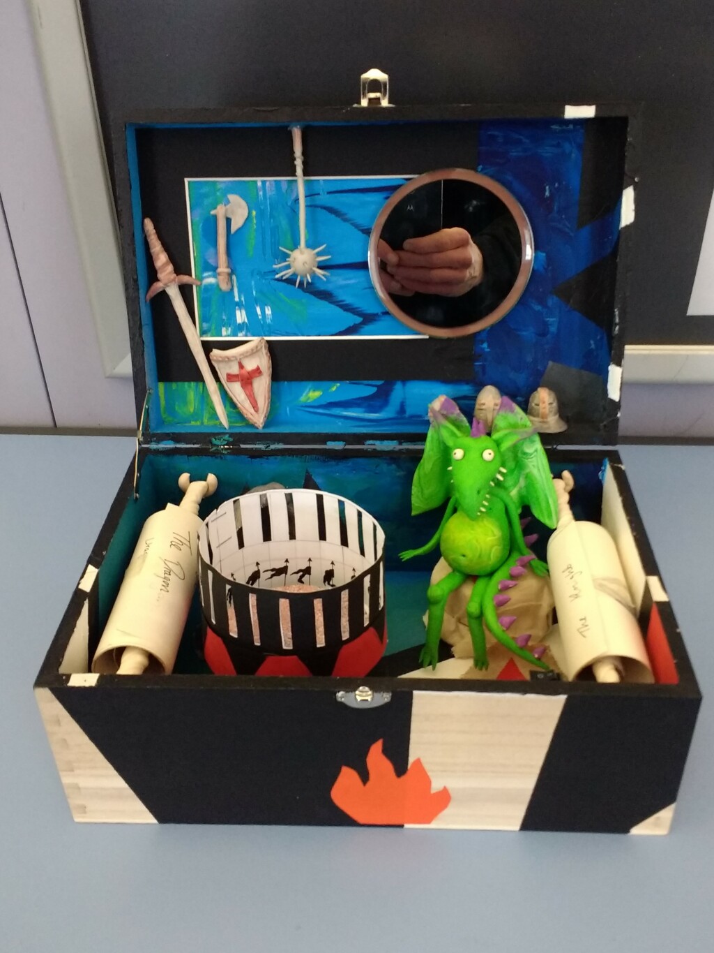 photo of a fantasy museum inside a shoebox, including an animation reel and clay dragon