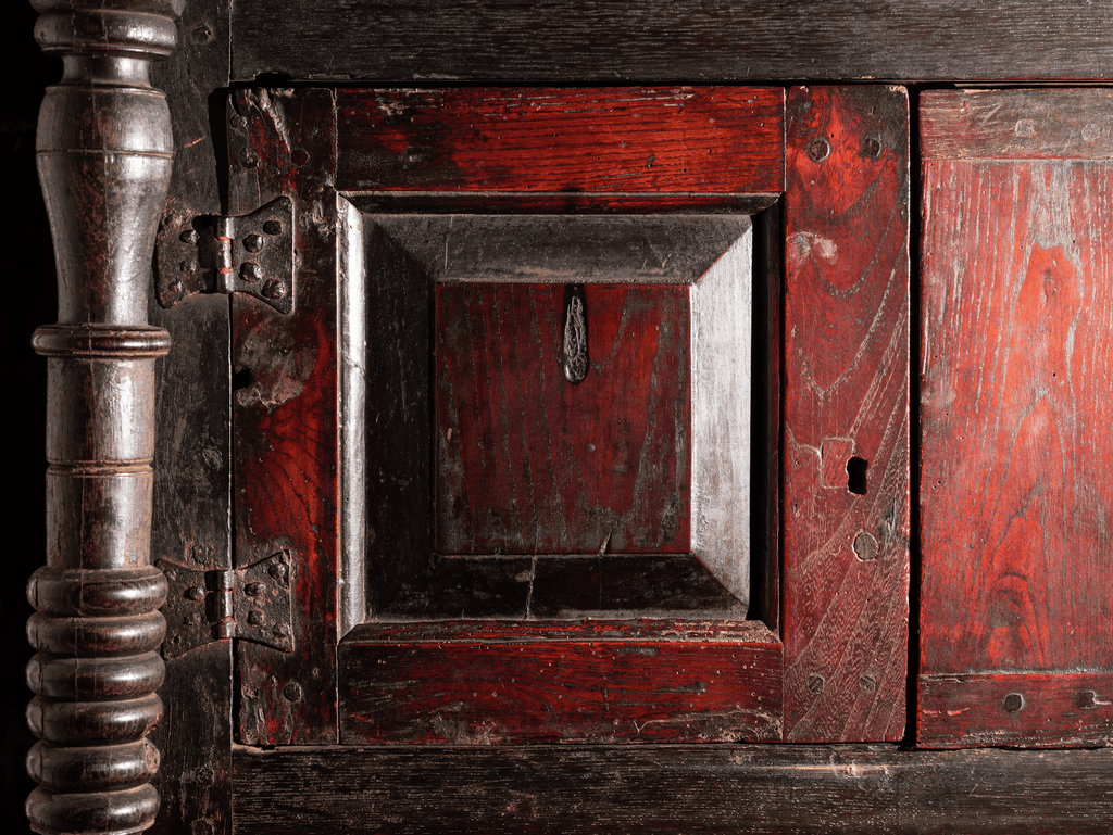 An image of a ritual burn mark on the door of a three-piece cupboard dated 1726.