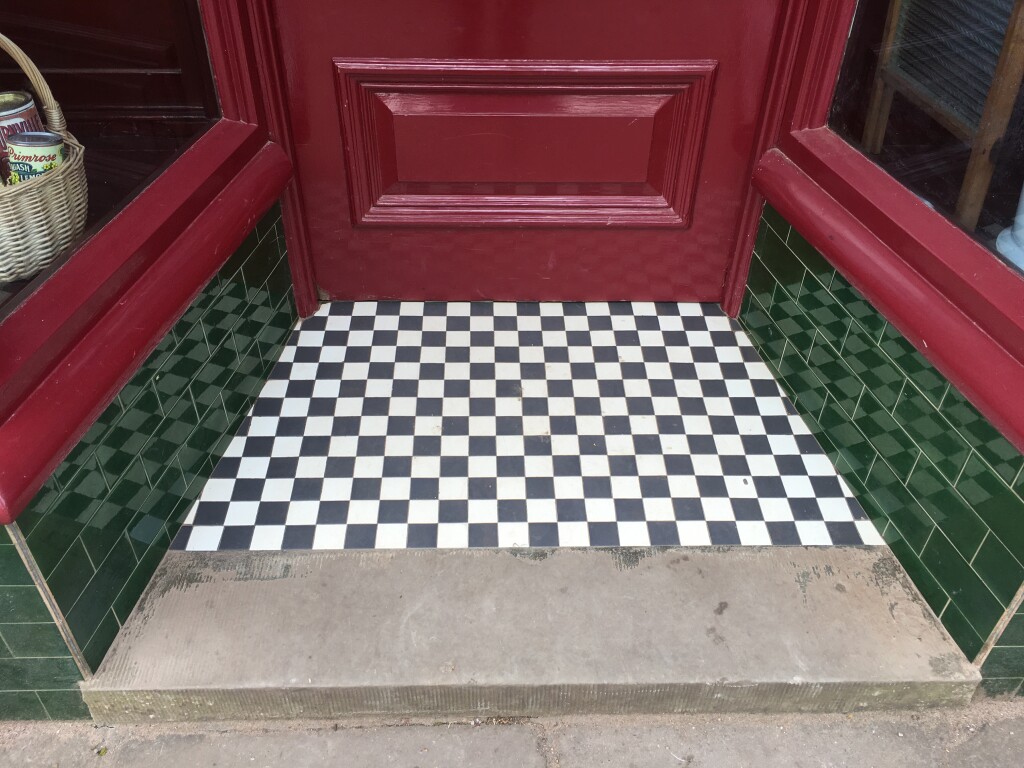 Image of threshold of Gwalia Stores at St Fagans national Museum of History. It is composed of alternating black and white squares.