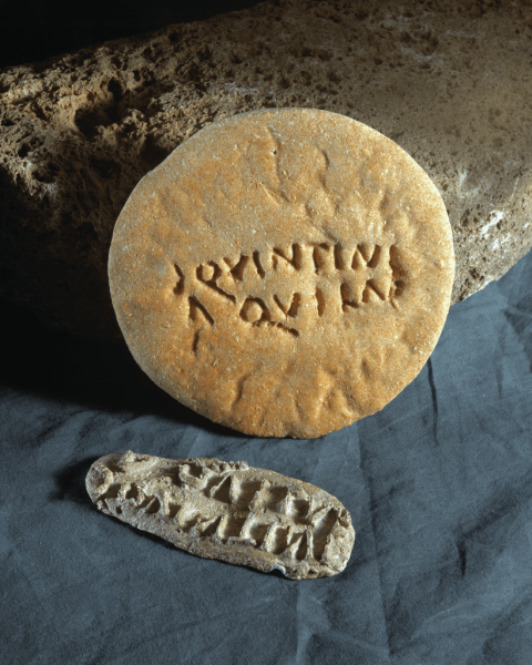 Lead bread-stamp and impressed flat bread. Prysg Field, Caerleon (NMW 32.60/6.1)