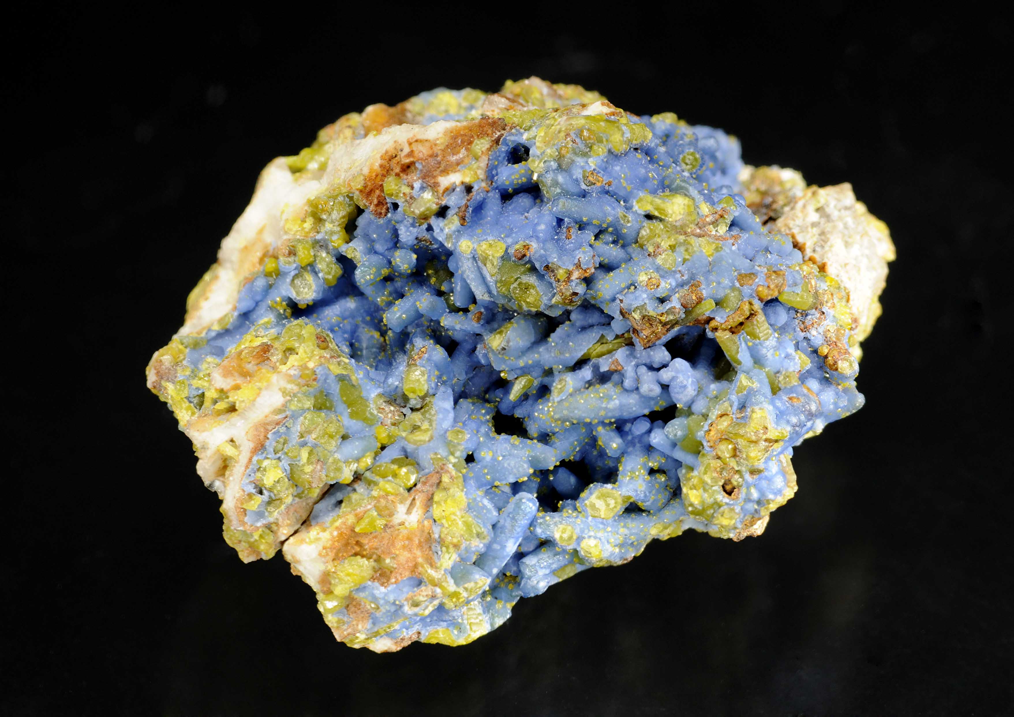 Brightly coloured secondary lead minerals: pyromorphite (green) and plumbogummite (blue) coating quartz veinstone from Roughton Gill, Caldbeck Fells, Cumbria, England. NMW 83.41G.M.7821.