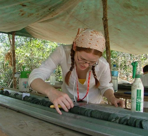 a scientist describing and sampling the core