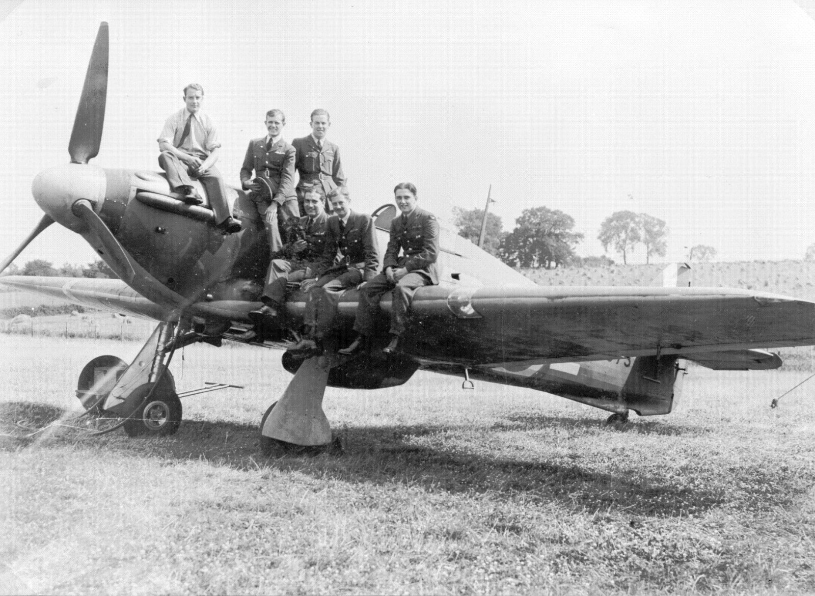 Griffiths (right) and other members of his squadron on a Hurricane.