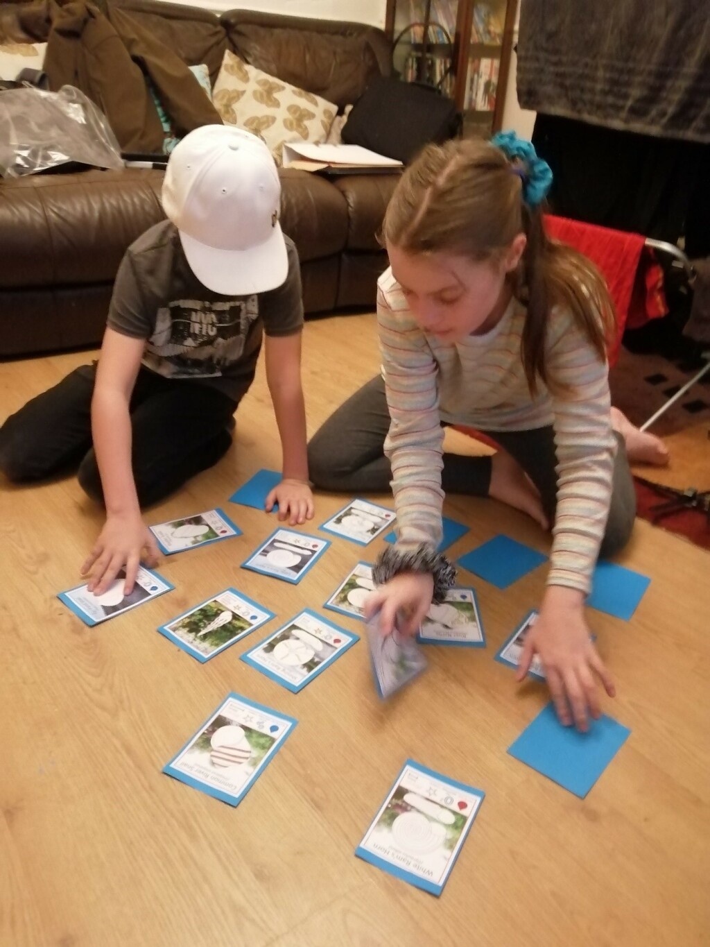 A picture of two children playing the Guess Whorl card game